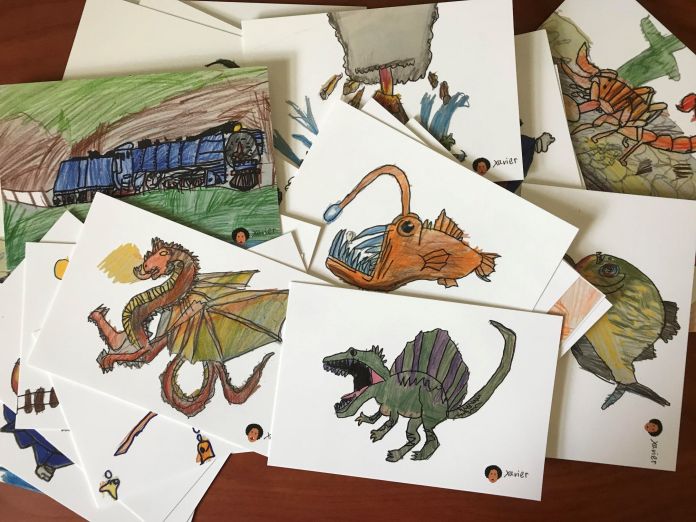 Postcards scattered with dragons, anglerfish, dinosaurs and trains